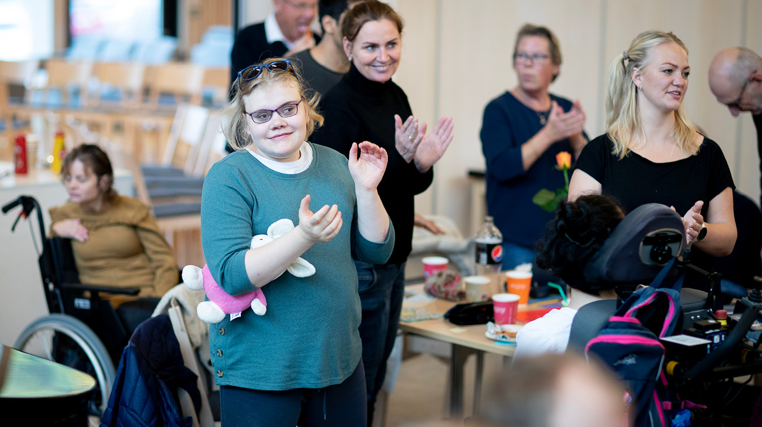 glad forsamling, flere klapper og smiler